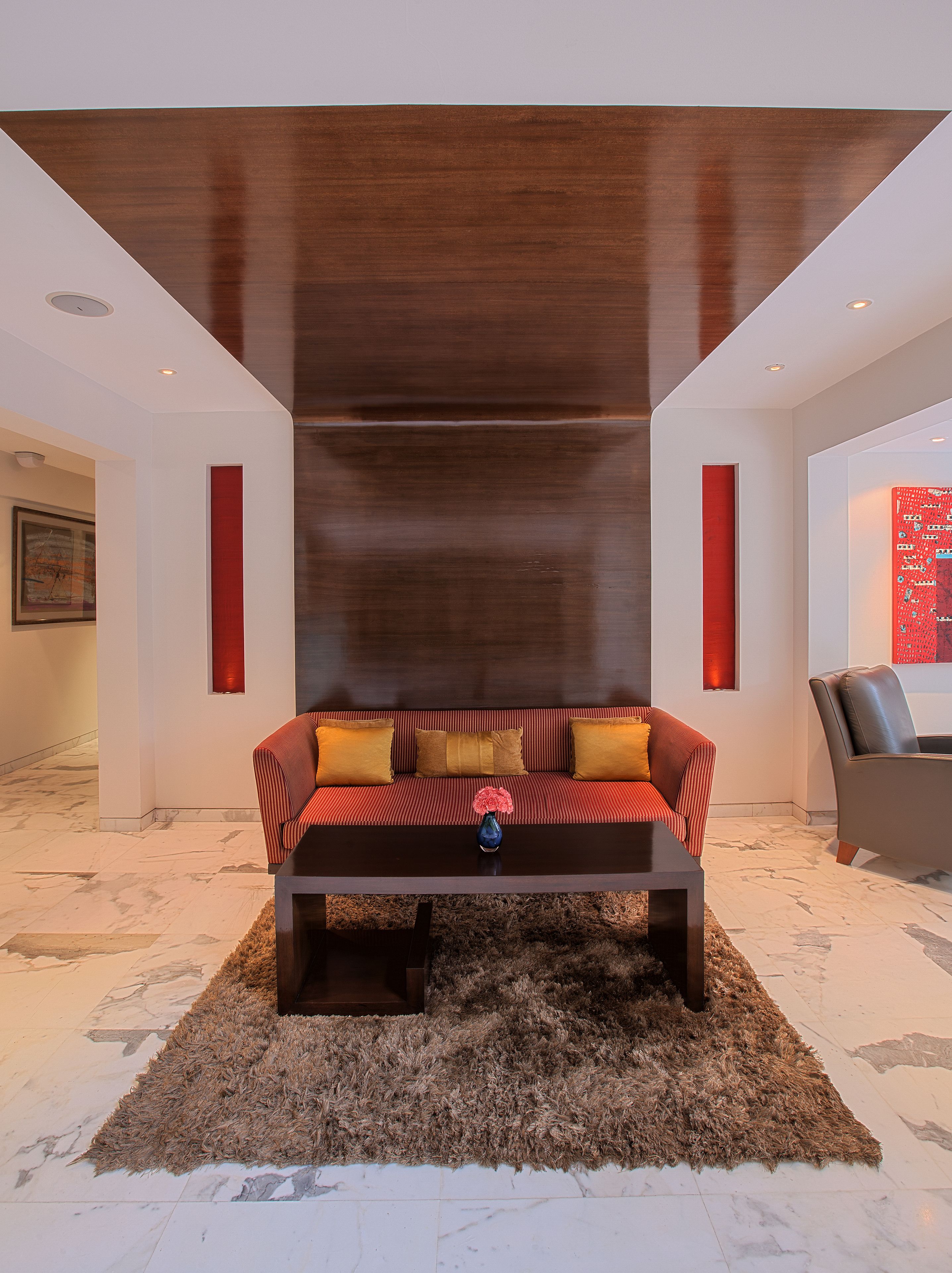 A modern living room with a sofa, a rug, and a coffee table.