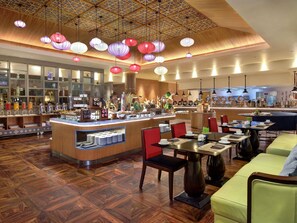 A restaurant with a central counter, seating area, and decorative hanging lanterns. - Grand Mercure Medan Angkasa (Medan)