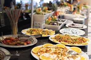 A buffet with various dishes, including roasted vegetables, salads, and a variety of other food items. - Dedeman Sanliurfa (Sanliurfa)