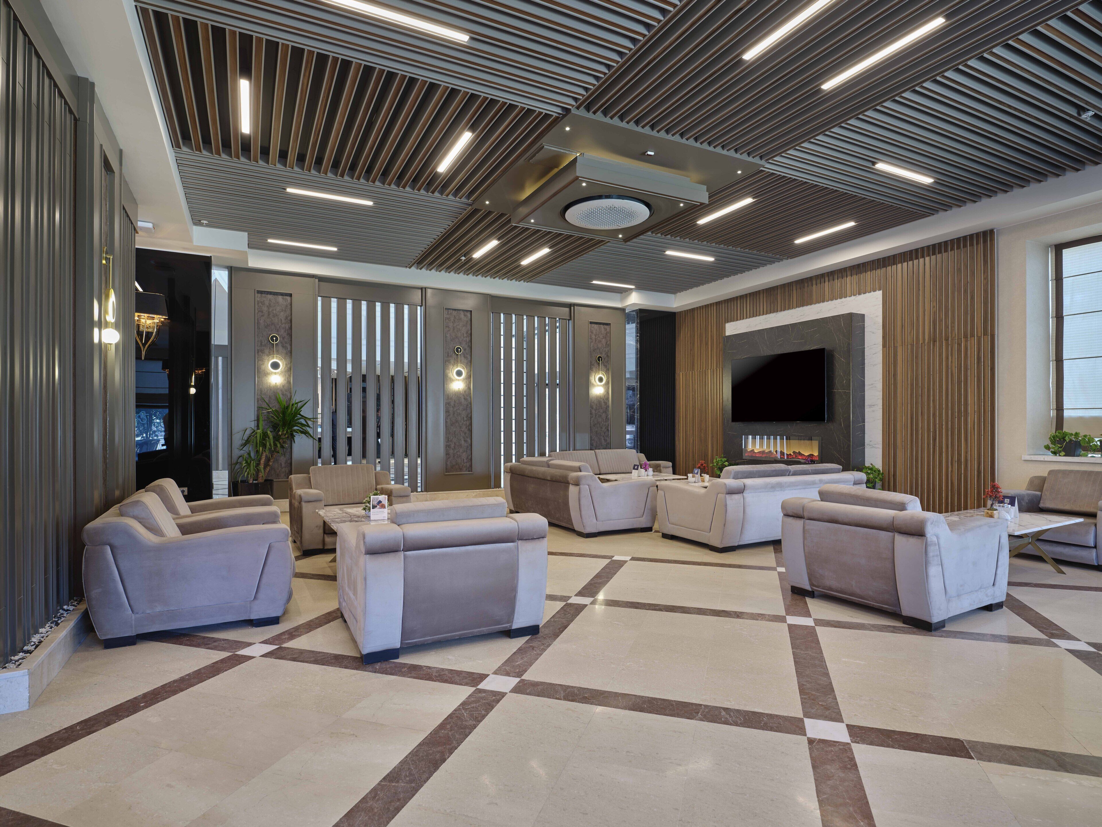 A modern living room with sofas and a flat-screen TV.