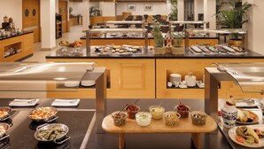 A buffet with various food stations, including fruits, vegetables, and prepared dishes. - Precise House Mantegna Roma (Rome)
