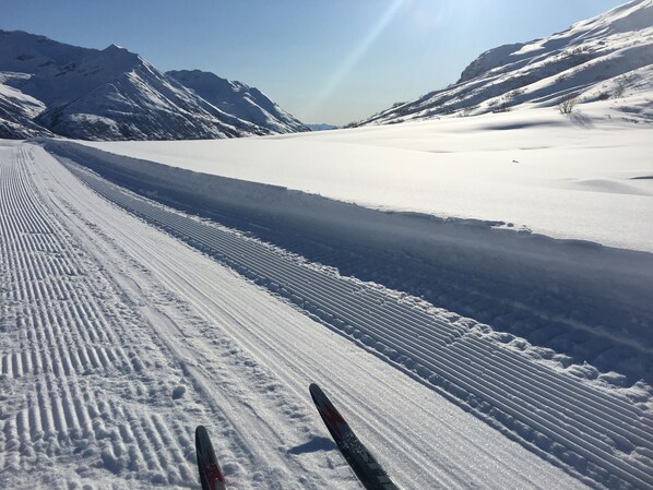 A snowy mountain landscape with ski tracks. - Hatcher Pass Cabins (Palmer)