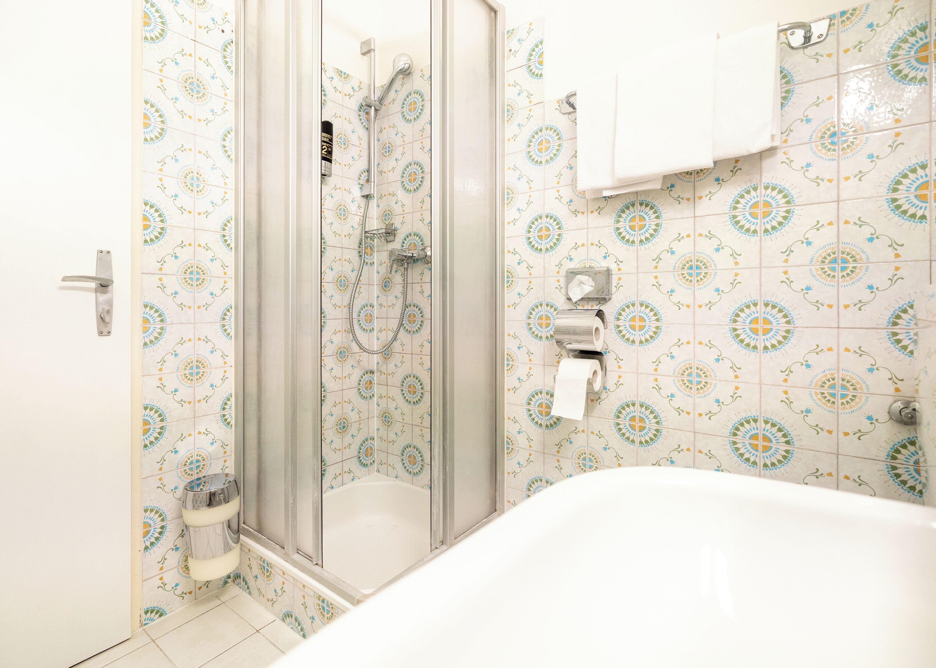 A bathroom with a shower, toilet, and bathtub.