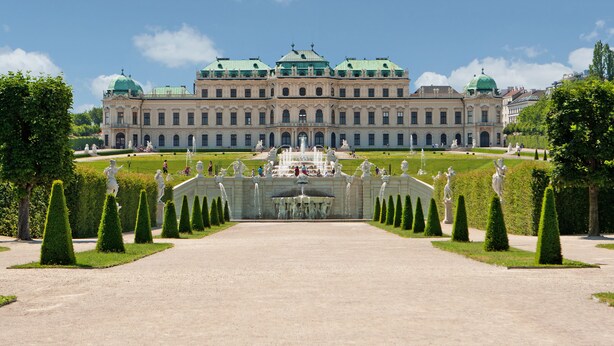 A large, historic building with a symmetrical facade, a central fountain, and a well-manicured garden with statues and hedges. - Lindner Hotel Vienna Am Belvedere, part of JdV by Hyatt (Vienna)