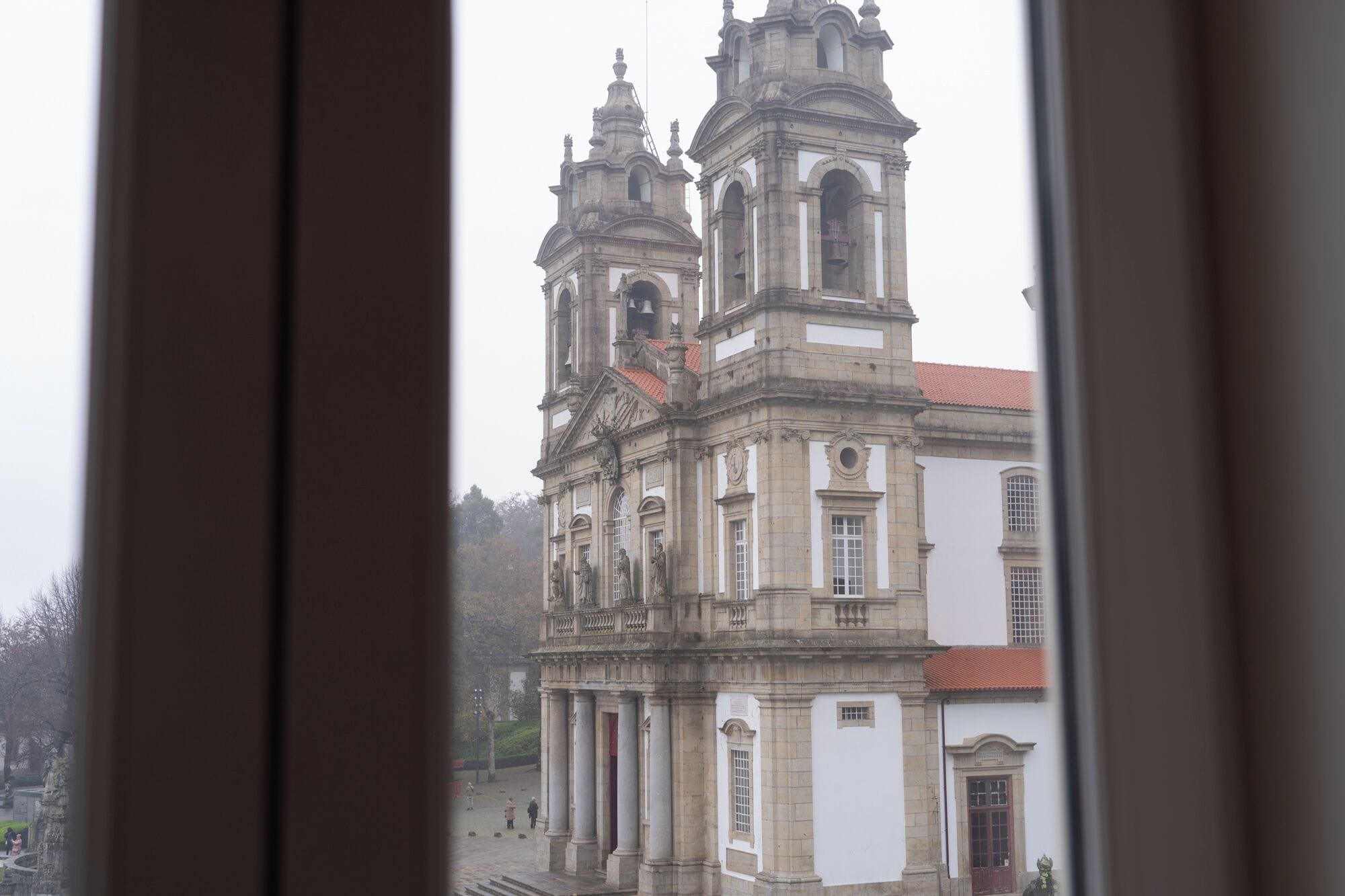 A historic building with classical architecture, featuring multiple towers and columns.