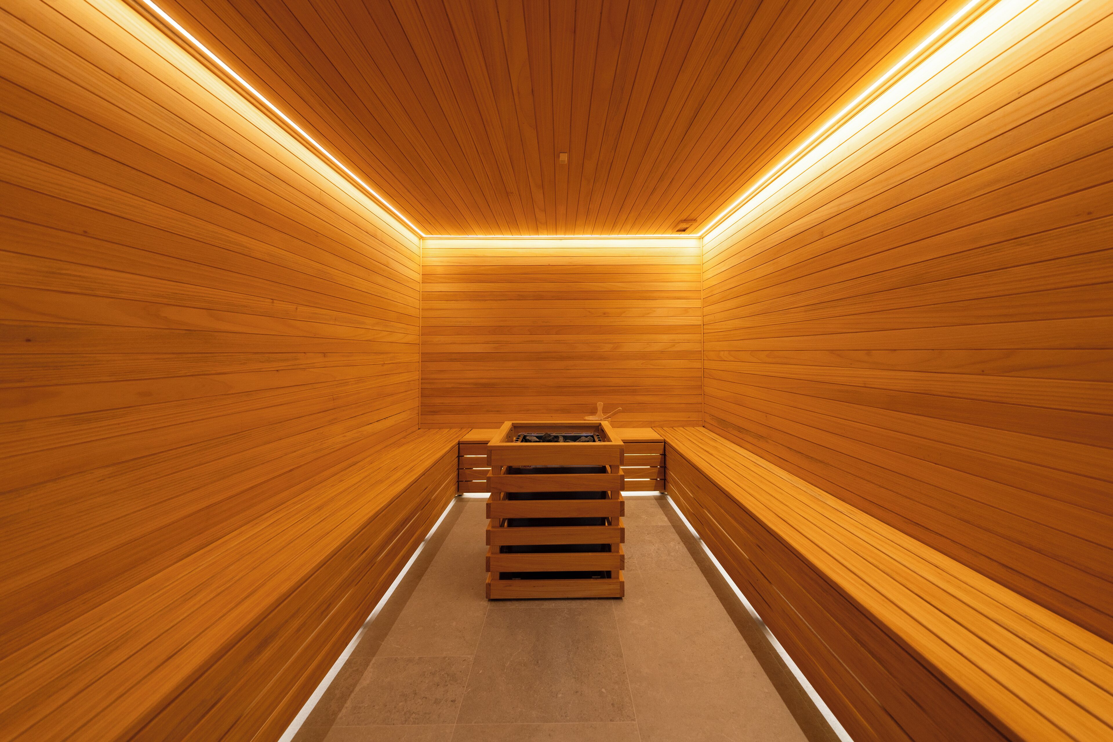 A sauna with wooden walls and benches.