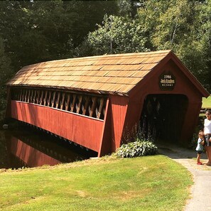 A covered bridge with a sign reading "1986 Jack Olsonen Resort." - Jack O'Lantern Resort and Golf Course (North Woodstock)