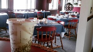 A restaurant with multiple tables and chairs, a chandelier, and large windows. - Jack O'Lantern Resort and Golf Course (North Woodstock)