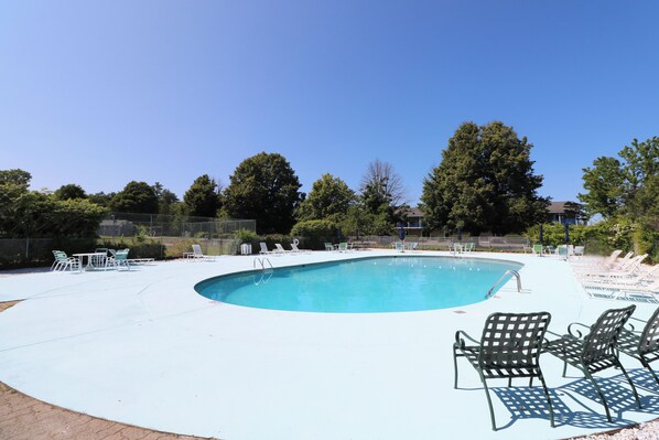 A swimming pool with lounge chairs and a fenced area. - The Majestic Regency Resort (Wells)