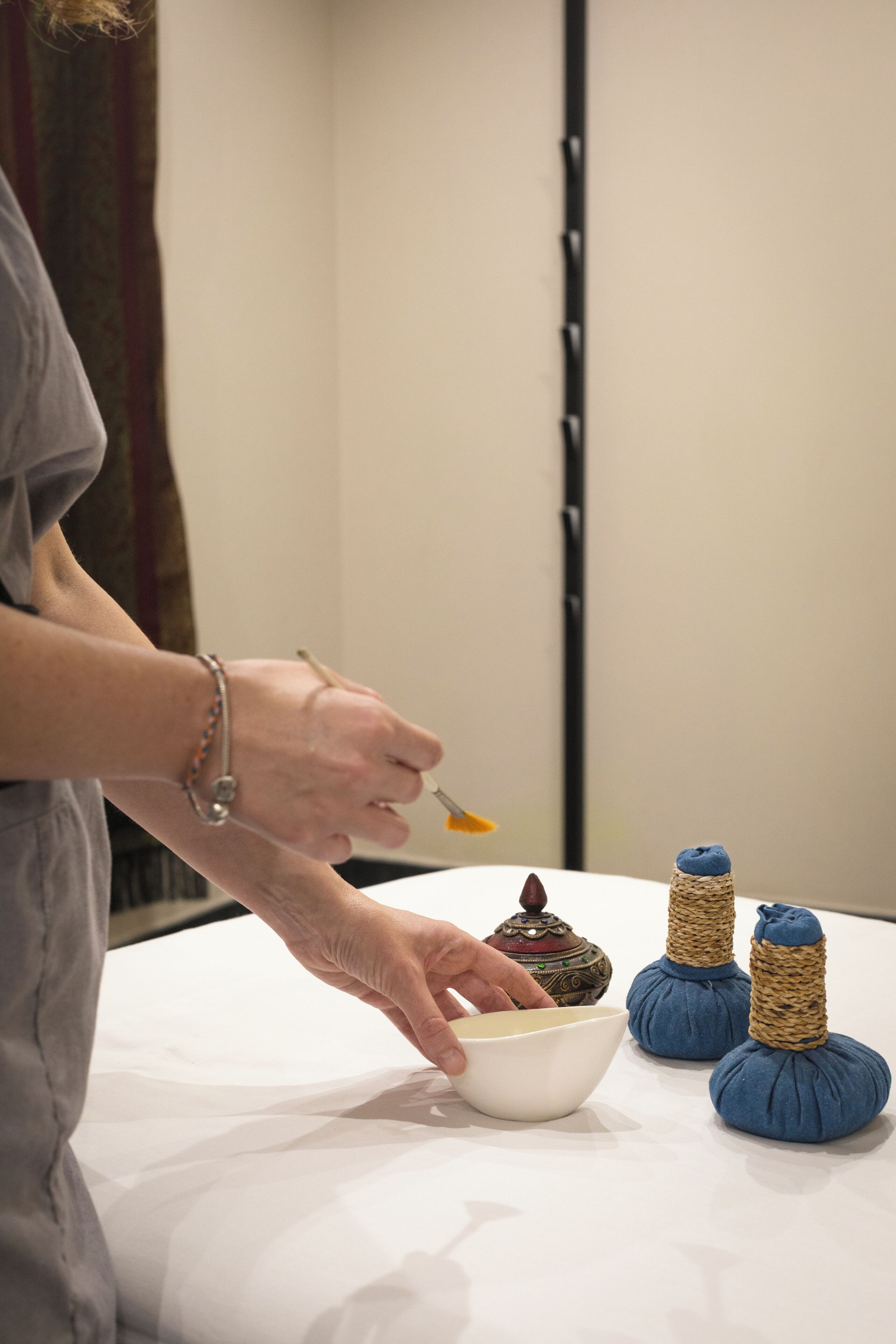 A person serving food from a bowl onto a plate.
