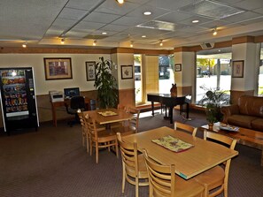 Relax in this spacious room with a dining table, comfortable sofa, and piano.