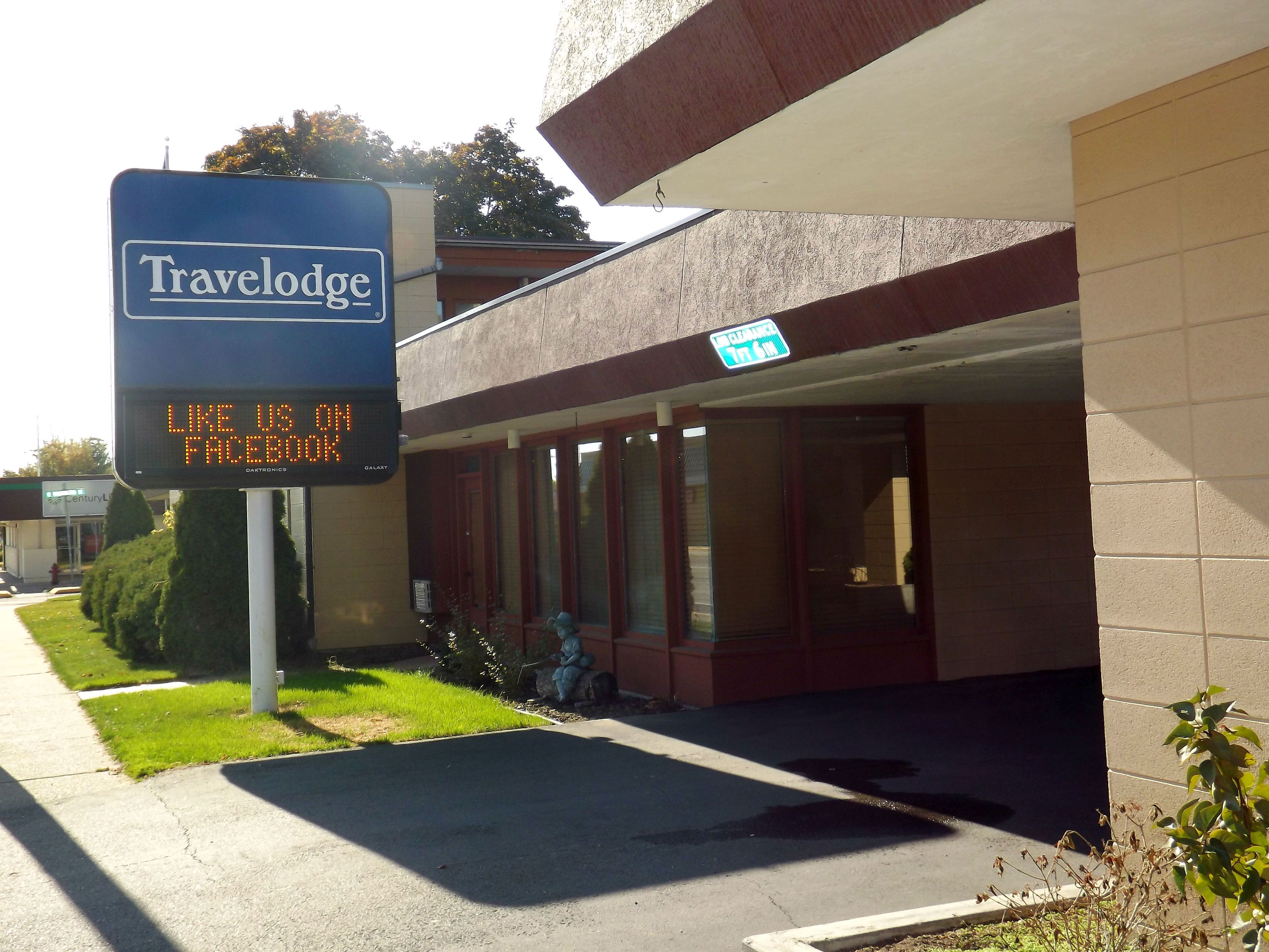 A Travelodge sign with a digital display encouraging Facebook likes.