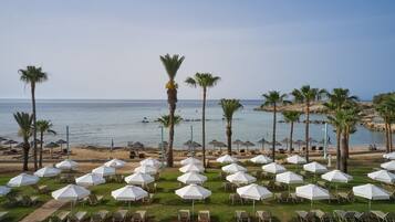 On the beach, sun-loungers, beach umbrellas, beach towels