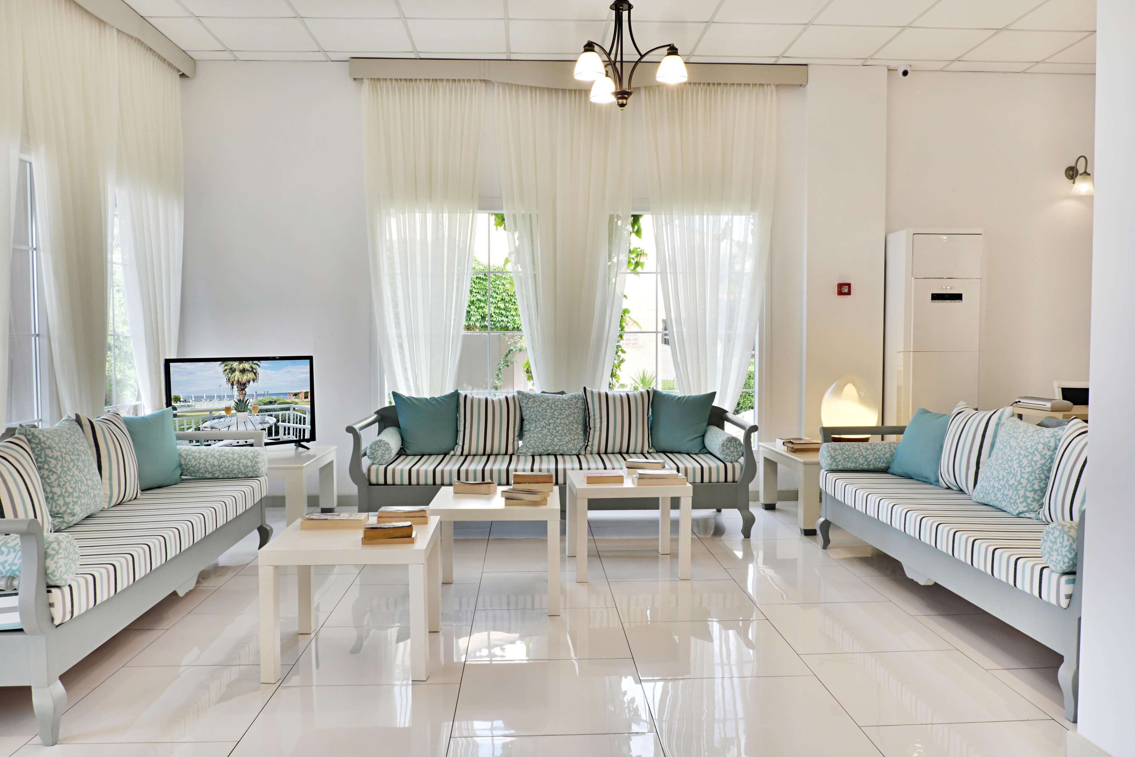A modern living room with two sofas, a coffee table, and a TV.