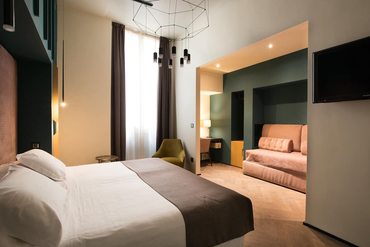 Premium Triple Room | Minibar, in-room safe, desk, blackout curtains