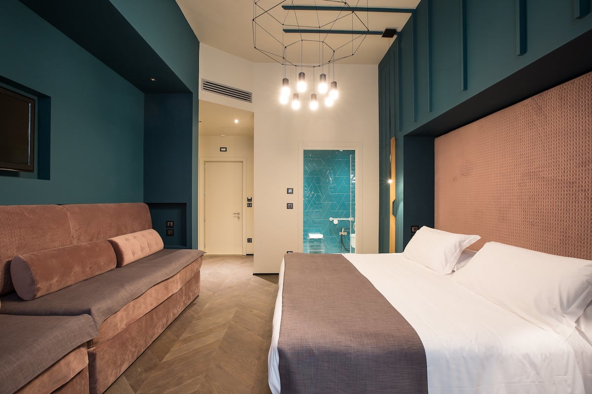 Premium Quadruple Room | Minibar, in-room safe, desk, blackout curtains