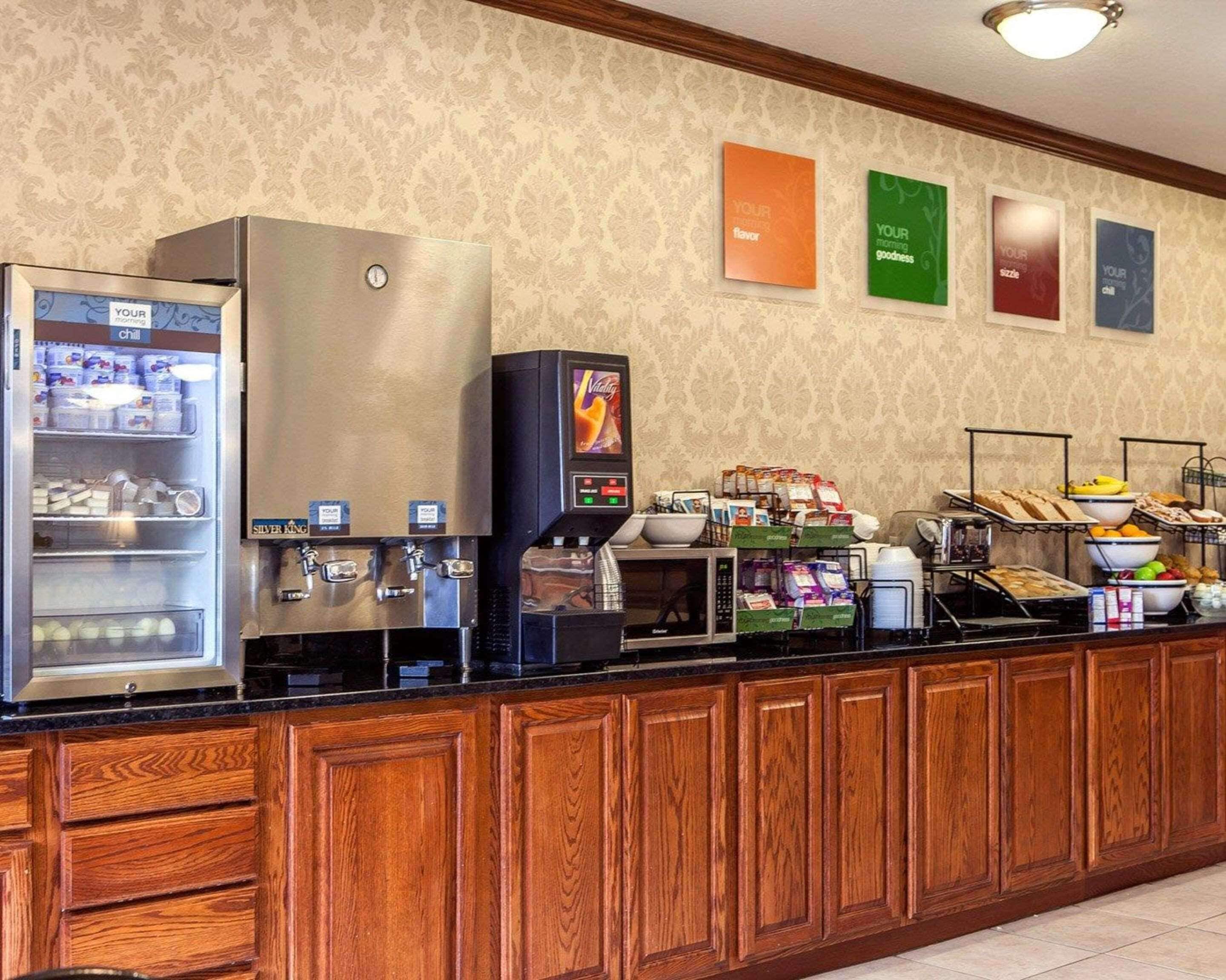 A self-service breakfast bar with a refrigerator, coffee machine, and a microwave.