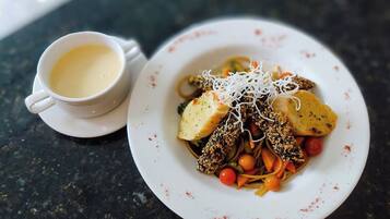 A plate of food with a cup of coffee.