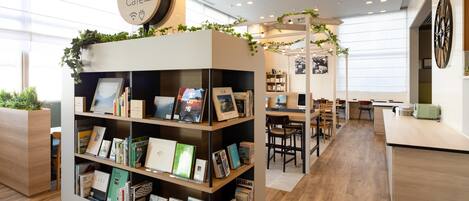 A modern library cafe with wooden bookshelves, a coffee machine, and a sign indicating a comfort library cafe.