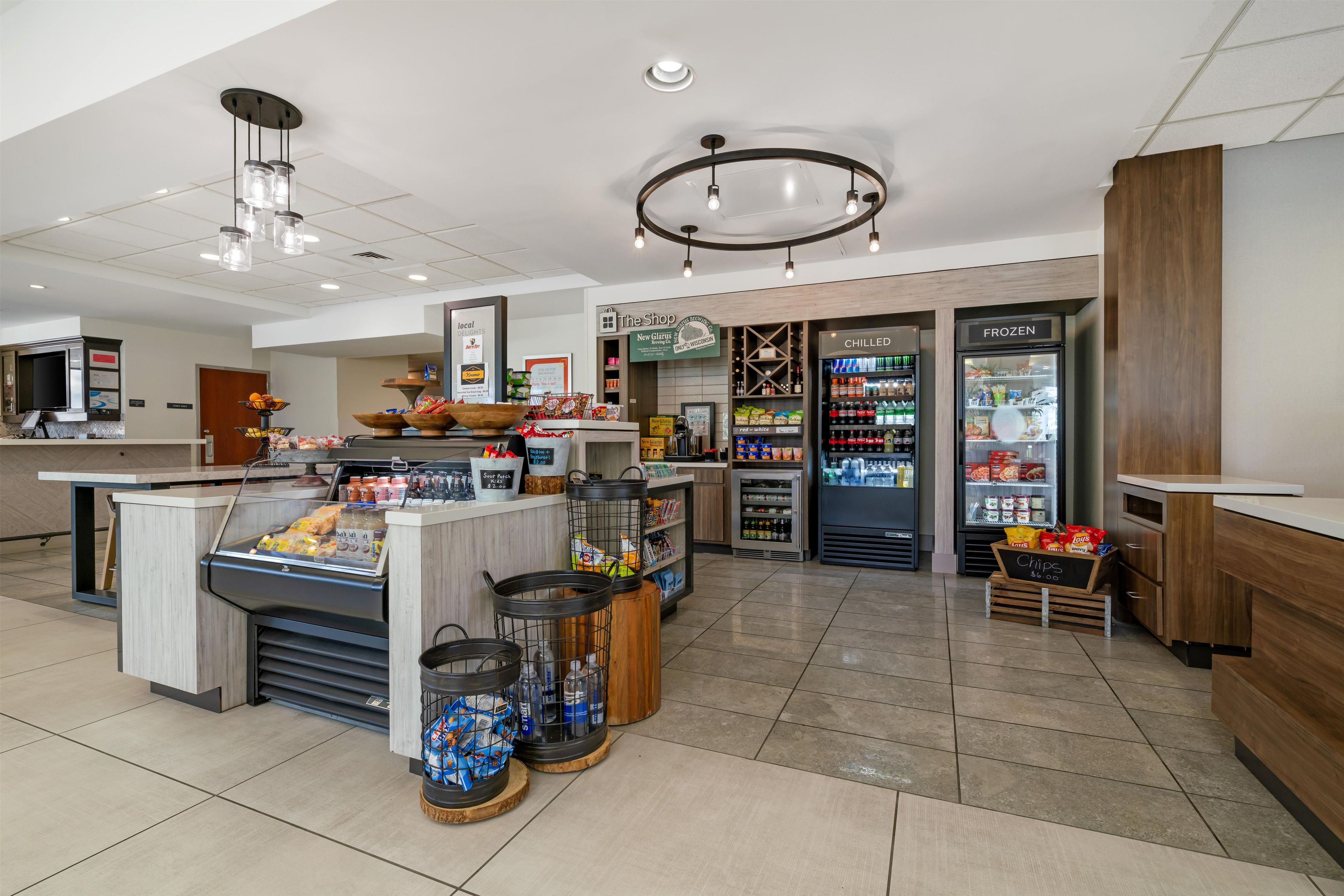 A self-service food station with a variety of snacks, a refrigerated section, and a coffee machine.