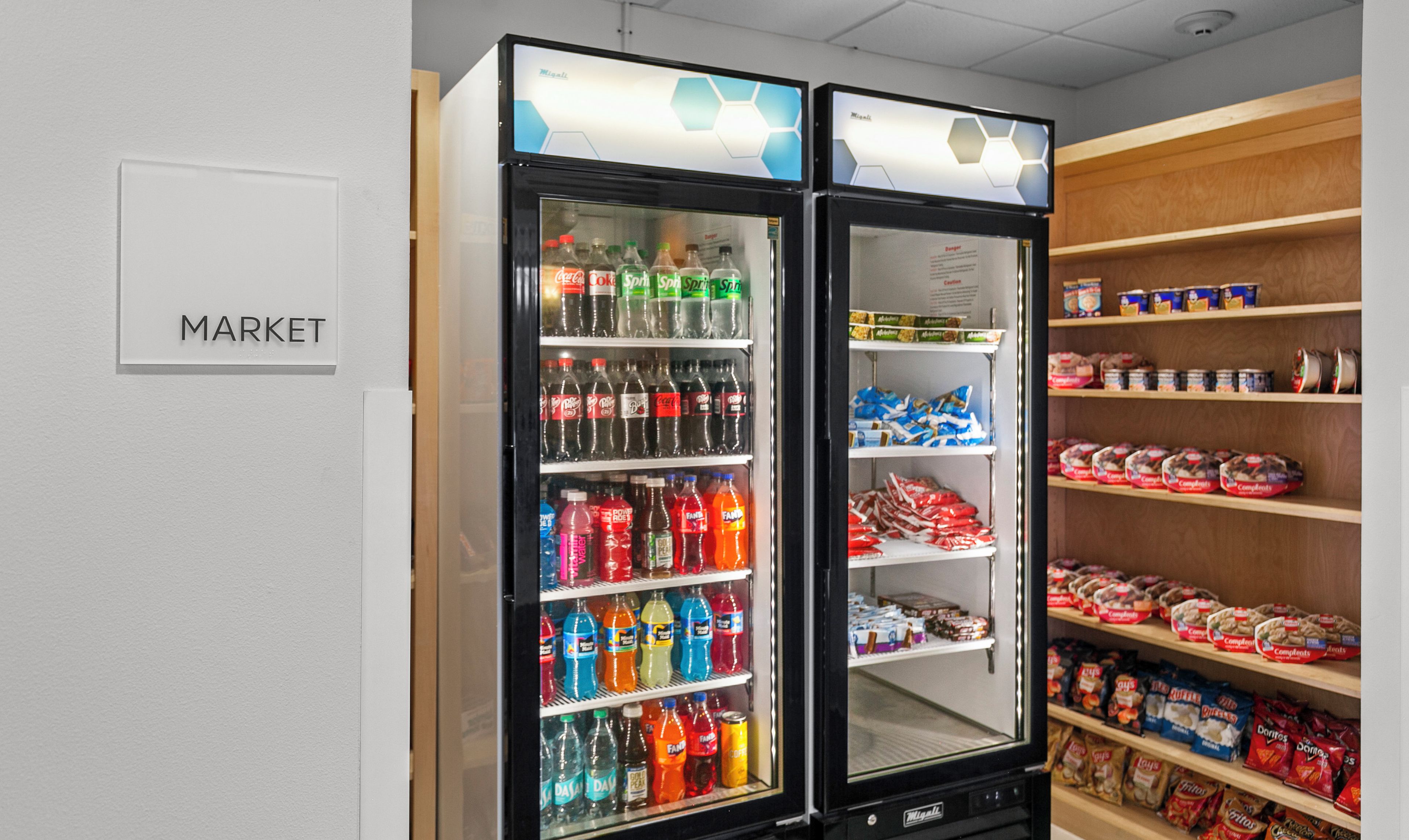 A vending machine area with a 'MARKET' sign, stocked with various beverages and snacks.