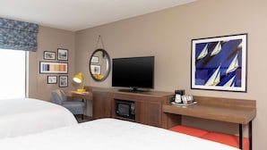 A hotel room with two beds, a desk with a computer, a TV, a microwave, and a coffee machine. - Hampton Inn Warsaw (Warsaw)
