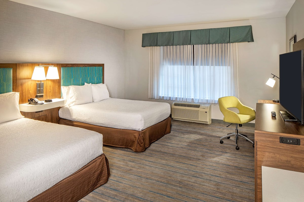 Premium bedding, pillow-top beds, desk, laptop workspace