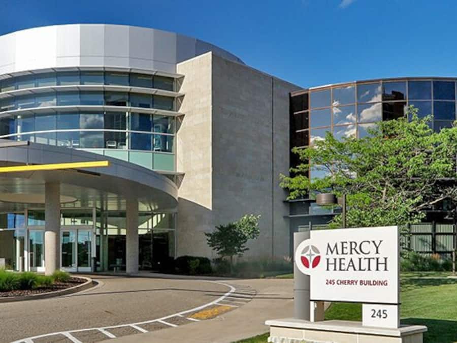 A modern building with a sign reading "Mercy Health 245 Cherry Building."