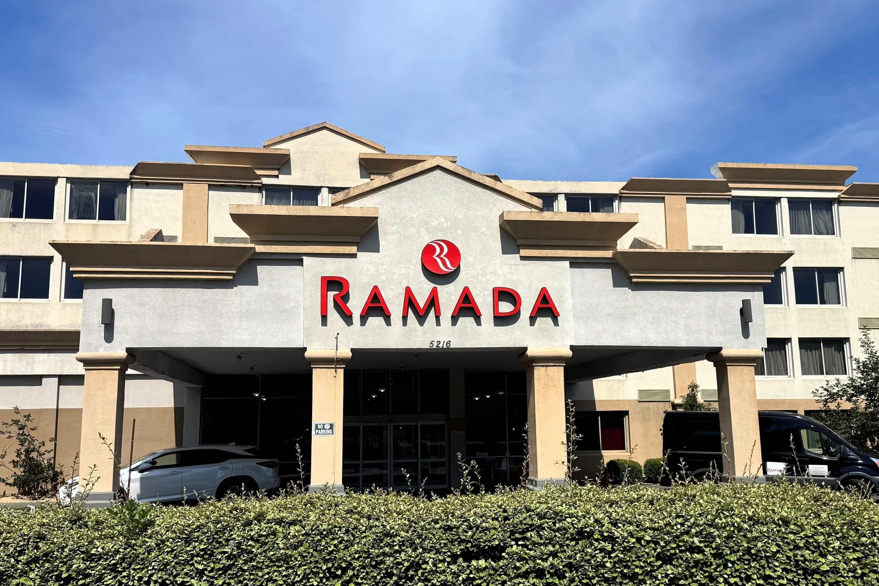 Ein Gebäude mit einem Schild, auf dem 'RAMADA' und darunter die Nummer '5216' steht.