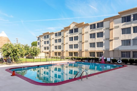 Una piscina al aire libre de temporada, sillones reclinables de piscina. Ramada by Wyndham Birmingham Airport