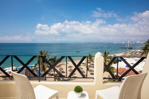 A balcony with a view of a beach and the ocean. -  Blue Chairs Beachfront Resort Puerto Vallarta Mexico - Adults Only (Puerto Vallarta)