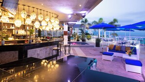 A bar area with a marble countertop, hanging lights, and a view of the ocean. -  Blue Chairs Beachfront Resort Puerto Vallarta Mexico - Adults Only (Puerto Vallarta)