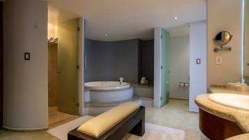 A modern bathroom with a freestanding bathtub, a bench, and a vanity with a mirror.