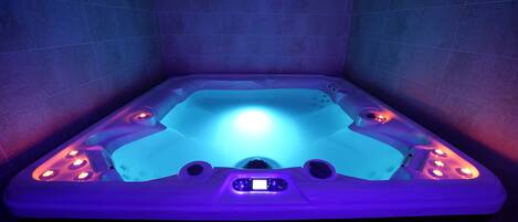 A hot tub with LED lighting and control panel.