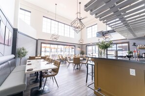 A spacious dining area with high ceilings, large windows, and modern pendant lighting. - Prestige Cranbrook Hotel, BW Premier Collection (Cranbrook)