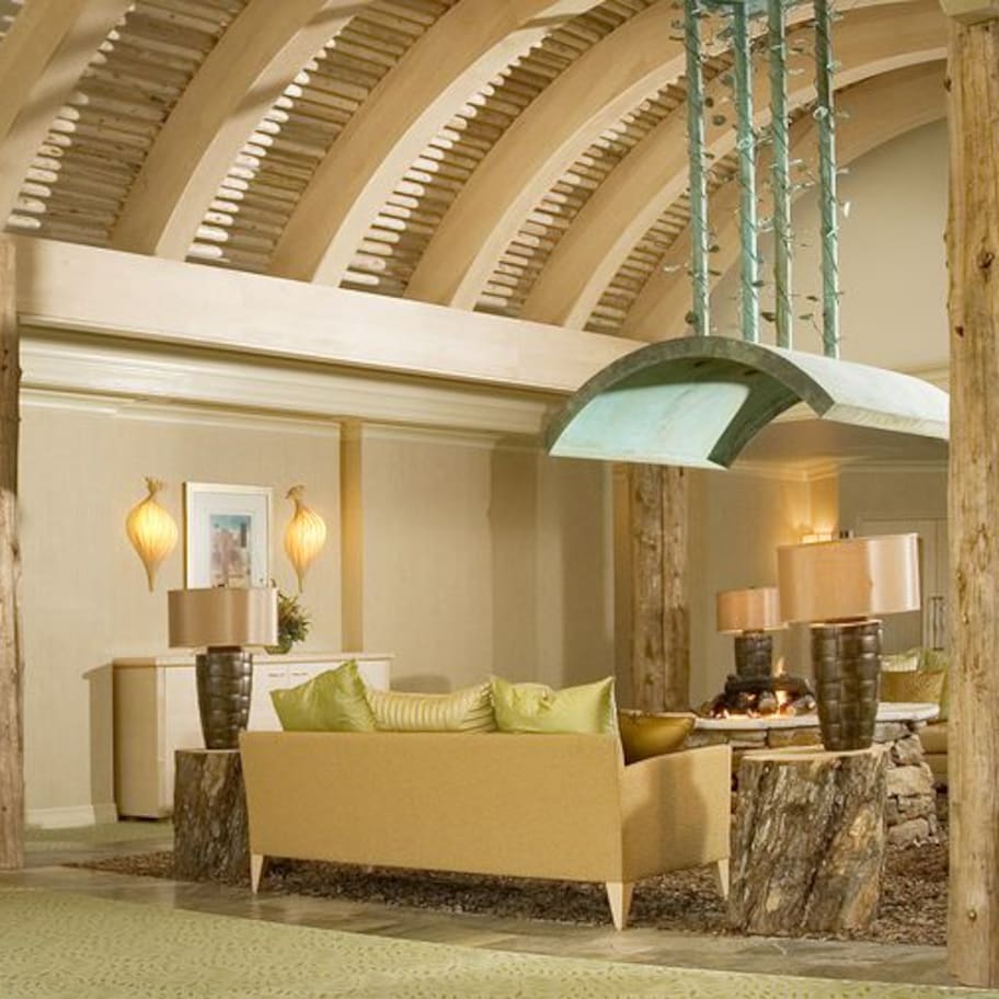 A reception area with a reception desk, seating area, and a large window.