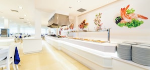 A modern buffet setup with a variety of food options and a clean, spacious layout. - Globales Samoa (Manacor)