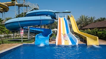 Enjoy thrilling water slides and a refreshing pool surrounded by lush greenery.
