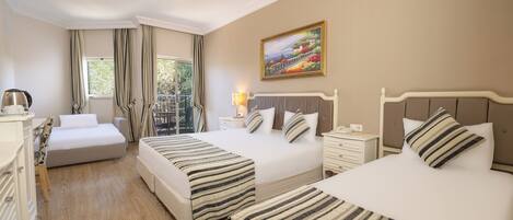 A hotel room with two beds, a desk, a chair, a nightstand, a lamp, and a painting on the wall.