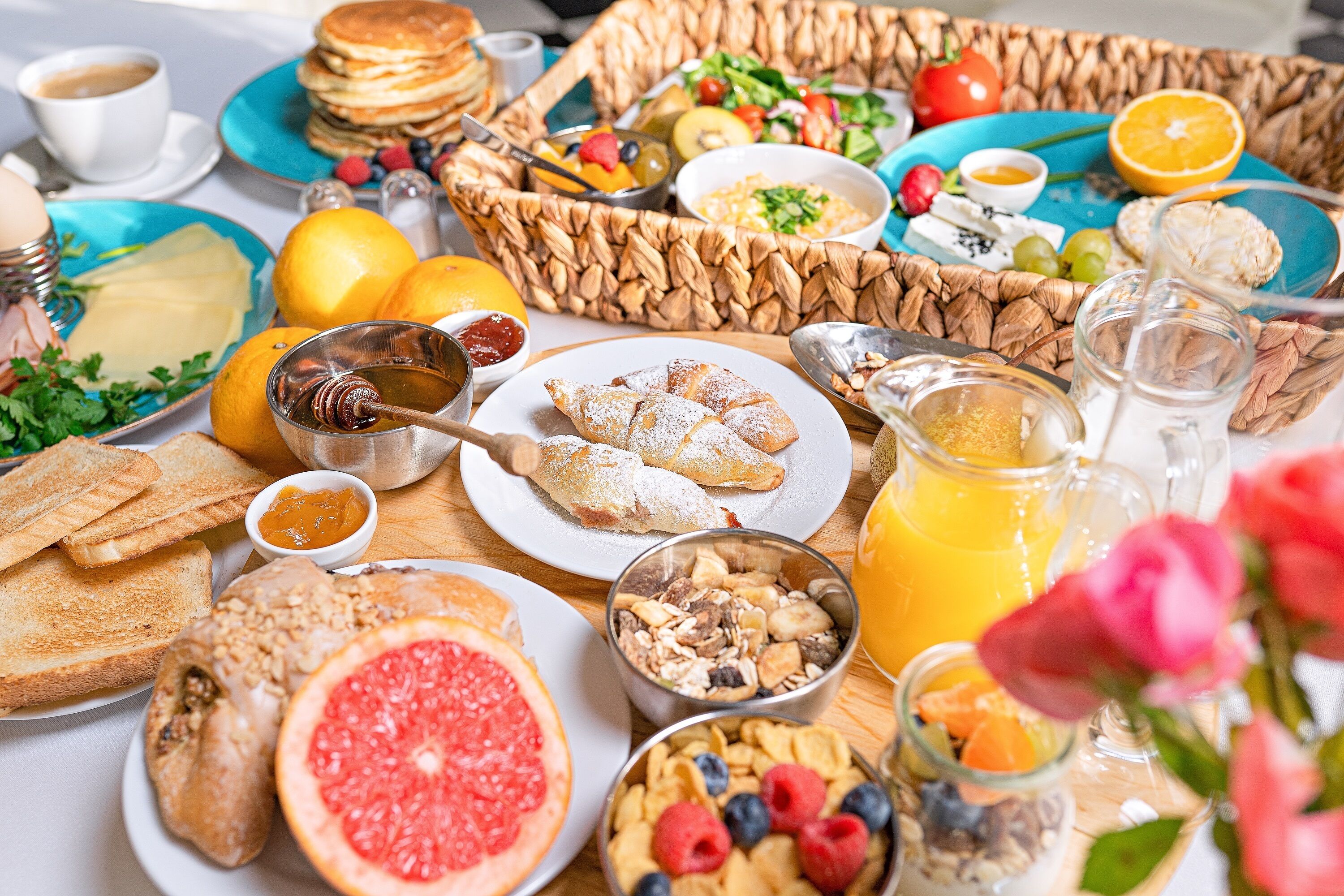 A breakfast buffet with various food items and beverages.