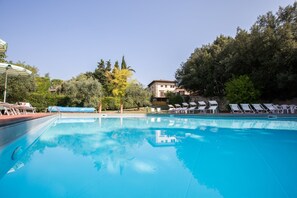 Seasonal outdoor pool, open 7 AM to 8:30 PM, pool umbrellas