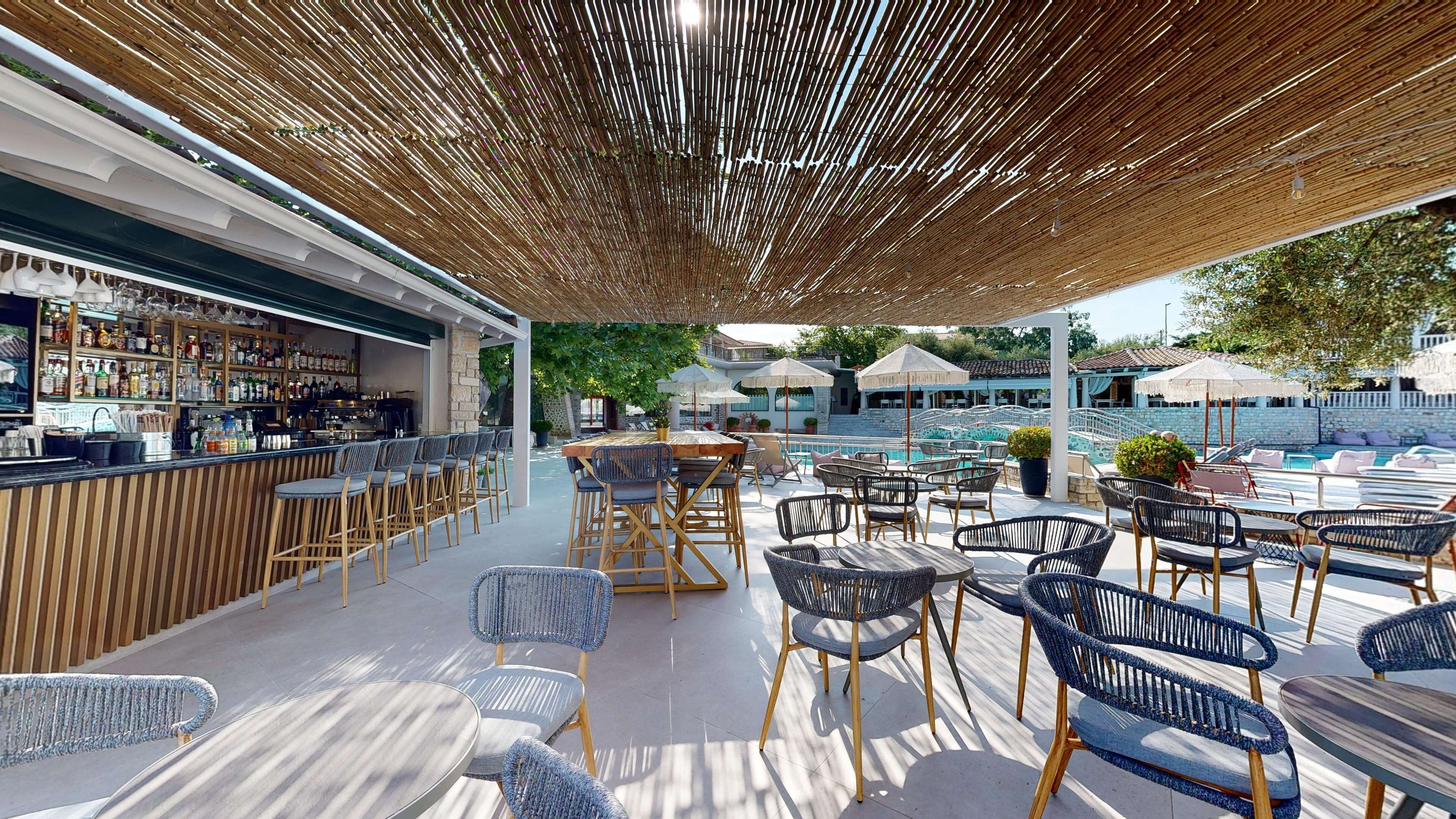 An outdoor bar area with wicker furniture and a poolside seating arrangement.