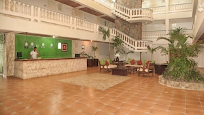 A spacious lobby with a reception desk, a staircase, and multiple seating areas. - Beach House Cabarete by Faranda Hotels (Cabarete)