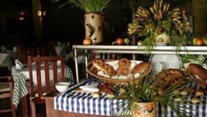 A buffet setup with plates, bowls, and a variety of food items. - Beach House Cabarete by Faranda Hotels (Cabarete)