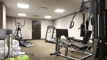 A gym with exercise equipment, a treadmill, and a stationary bike.
