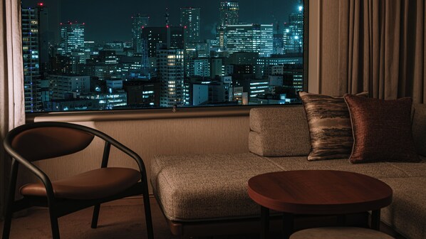 A modern living room with a view of a cityscape at night. - Sapporo Prince Hotel (Sapporo)