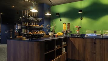 A kitchen with wooden cabinets, a counter with food items, and pendant lights.