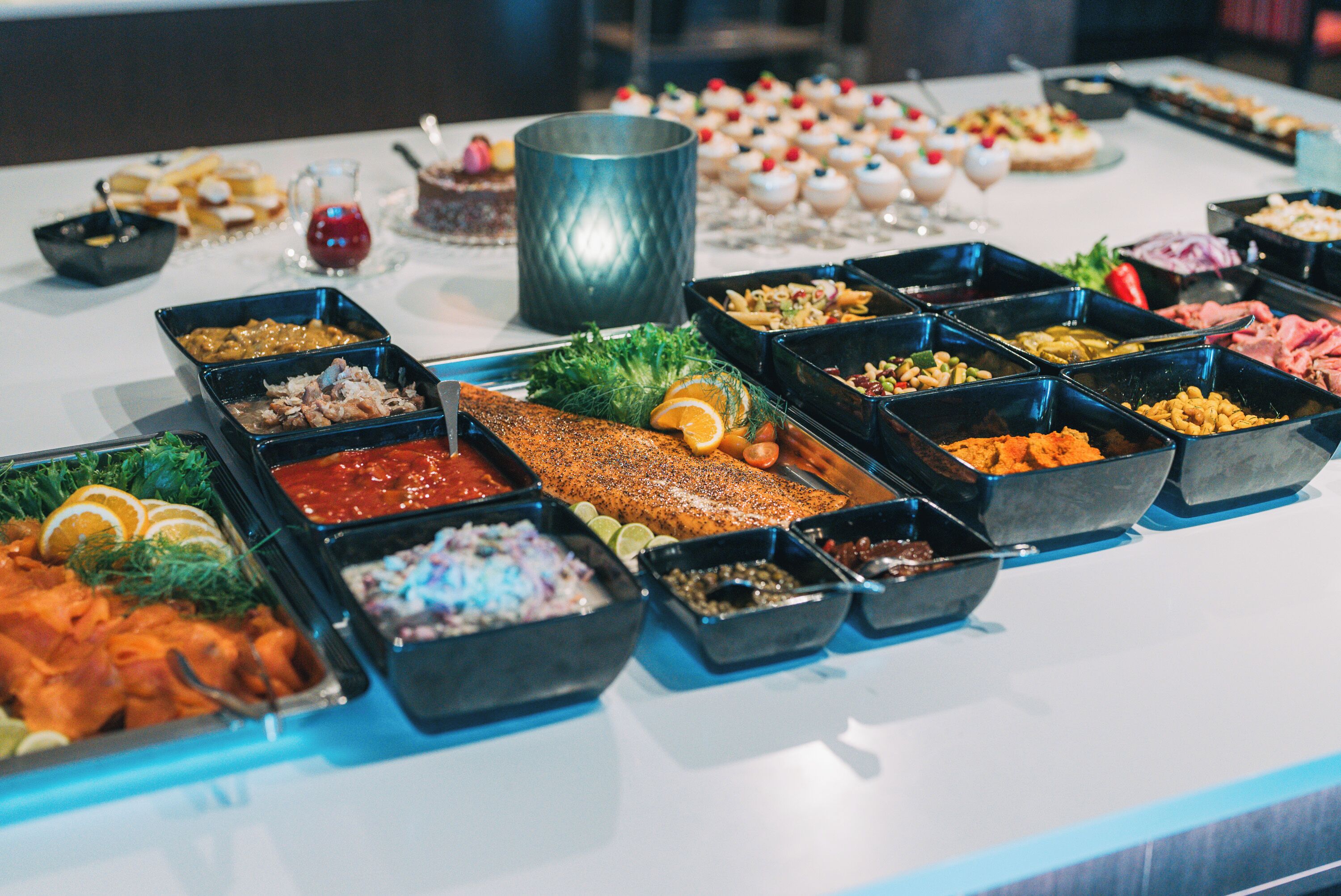 A buffet with various food items and a large metal container.