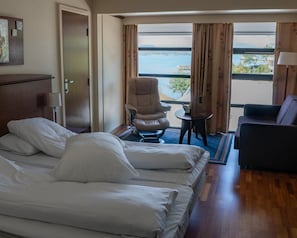 A hotel room with a bed, a chair, a small table, and a sofa. - Fitjar Fjord Hotel (Fitjar)
