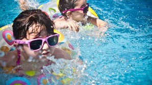 Two people in a swimming pool with colorful water toys. - Holiday Inn Manassas - Battlefield by IHG (Manassas)